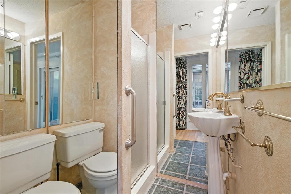 702 Keywe Place Duncanville, TX 75116 - Photo 17 of 40 a bathroom with a sink toilet and shower glass cabinet