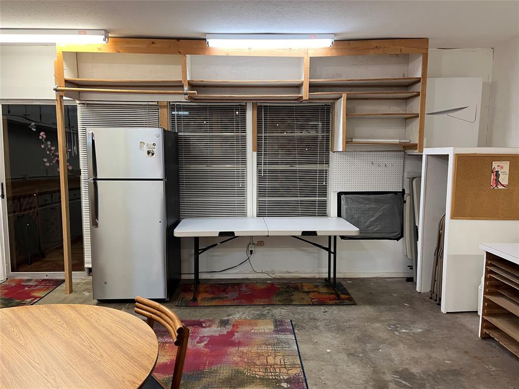702 Keywe Place Duncanville, TX 75116 - Photo 19 of 40 a kitchen with a refrigerator and a table