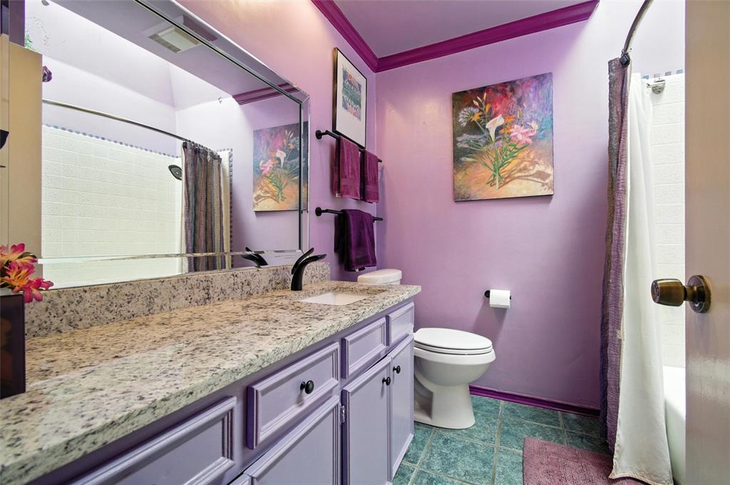 702 Keywe Place Duncanville, TX 75116 - Photo 26 of 40 a bathroom with a granite countertop toilet sink and mirror