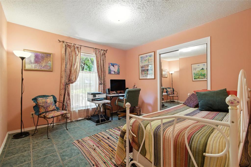 702 Keywe Place Duncanville, TX 75116 - Photo 27 of 40 a bedroom with a bed and a couch