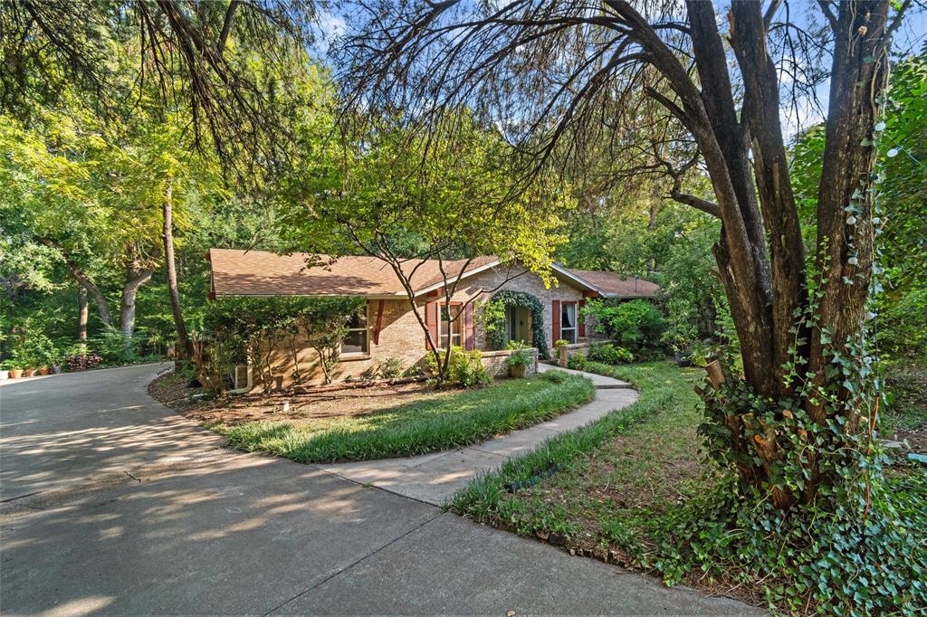702 Keywe Place Duncanville, TX 75116 - Photo 34 of 40 a view of a small yard in front of a house with large trees