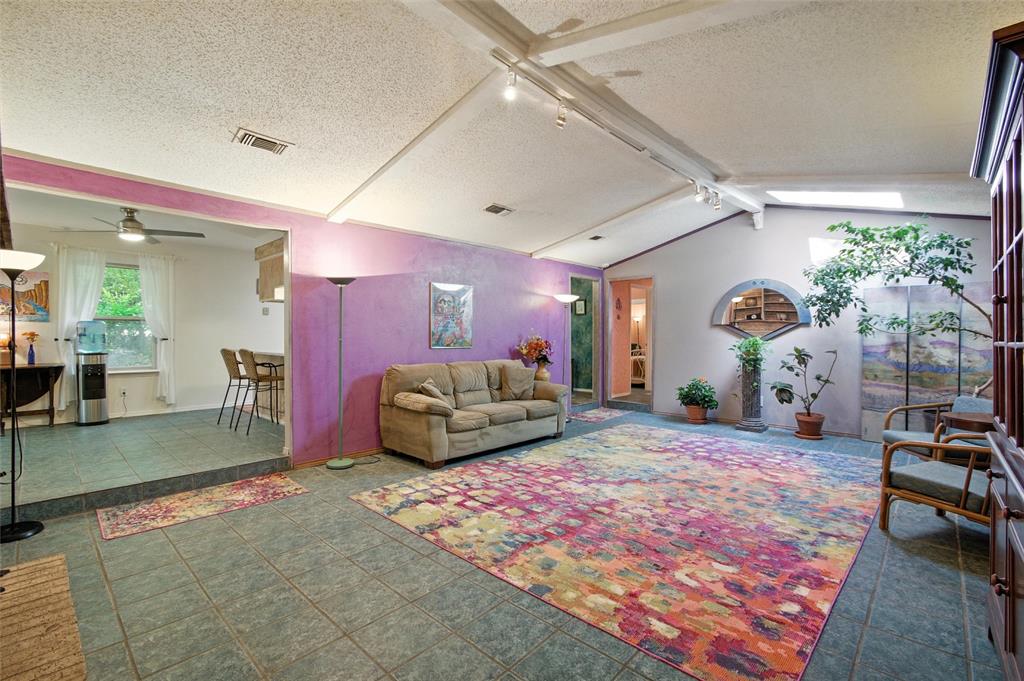 702 Keywe Place Duncanville, TX 75116 - Photo 5 of 40 a spacious bedroom with a bed a table and chair