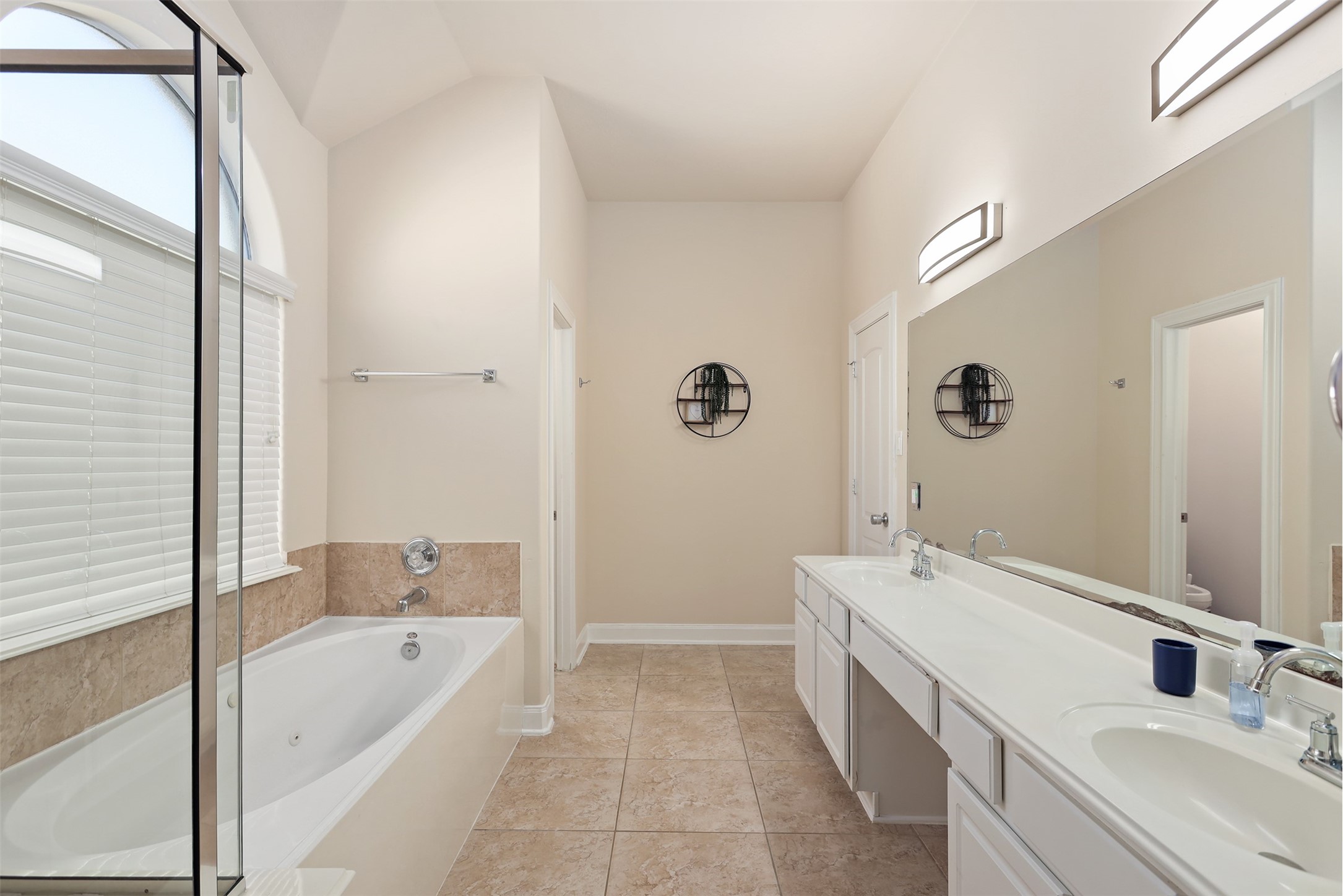 5026 Gulf Stream Lane Bacliff, TX 77518 - Photo 11 of 20 a bathroom with a tub sink and mirror