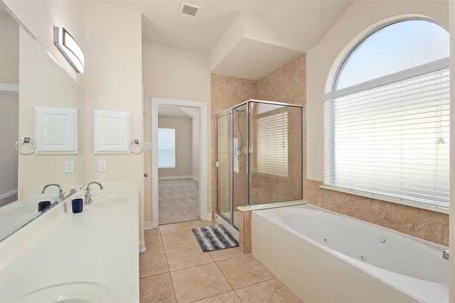 a bathroom with a bathtub and shower