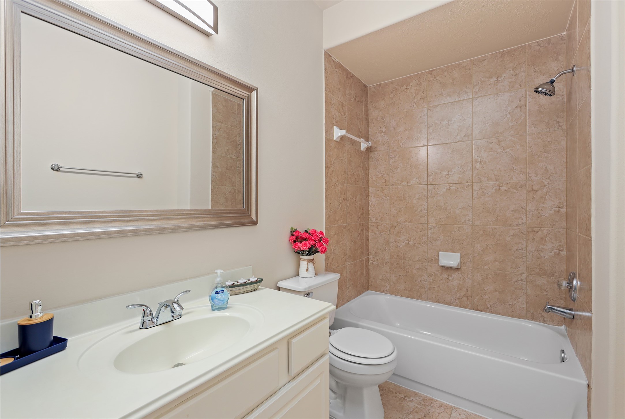 5026 Gulf Stream Lane Bacliff, TX 77518 - Photo 14 of 20 a bathroom with a sink mirror toilet and bathtub