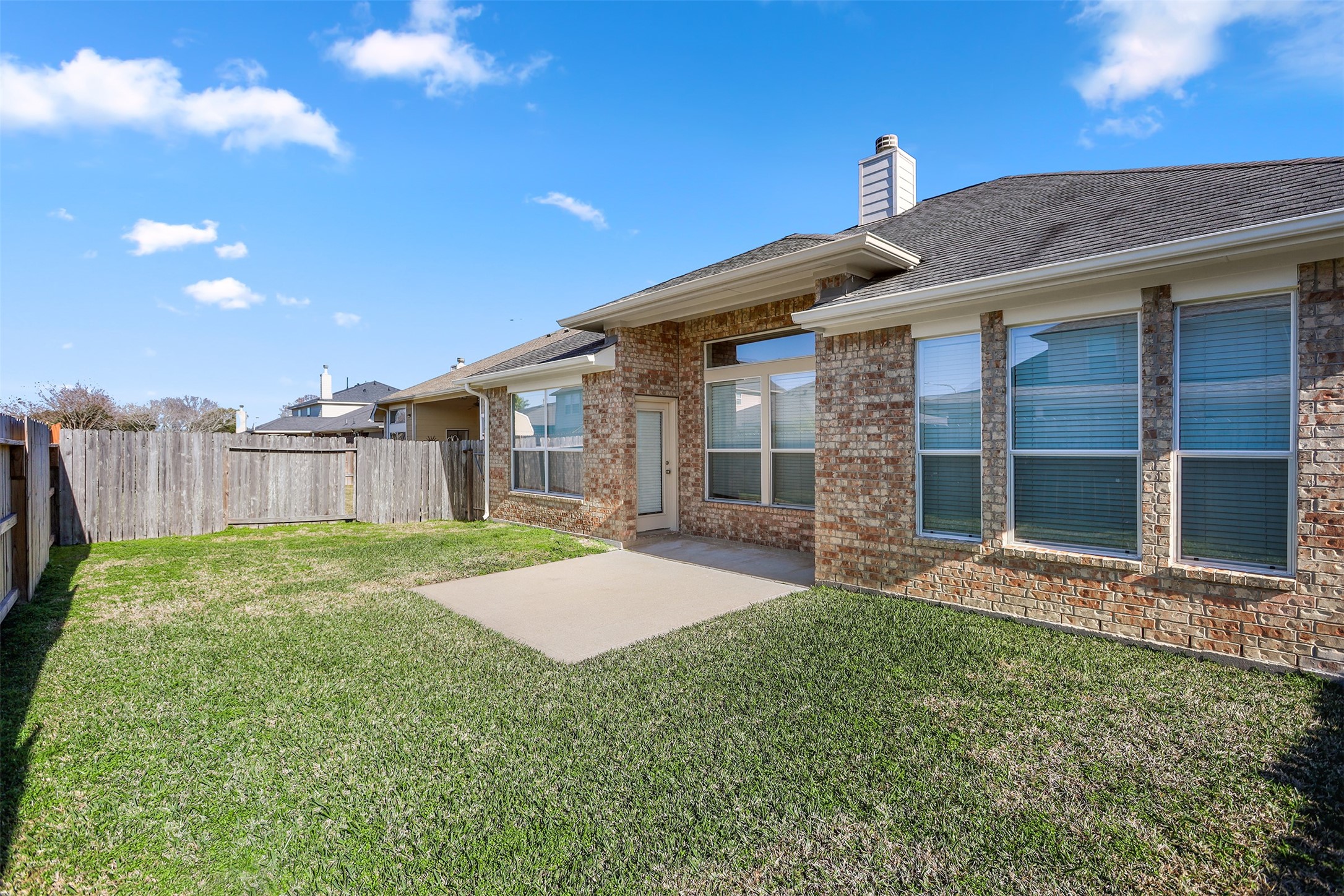 5026 Gulf Stream Lane Bacliff, TX 77518 - Photo 19 of 20 a view of a backyard with table and chairs and wooden fence