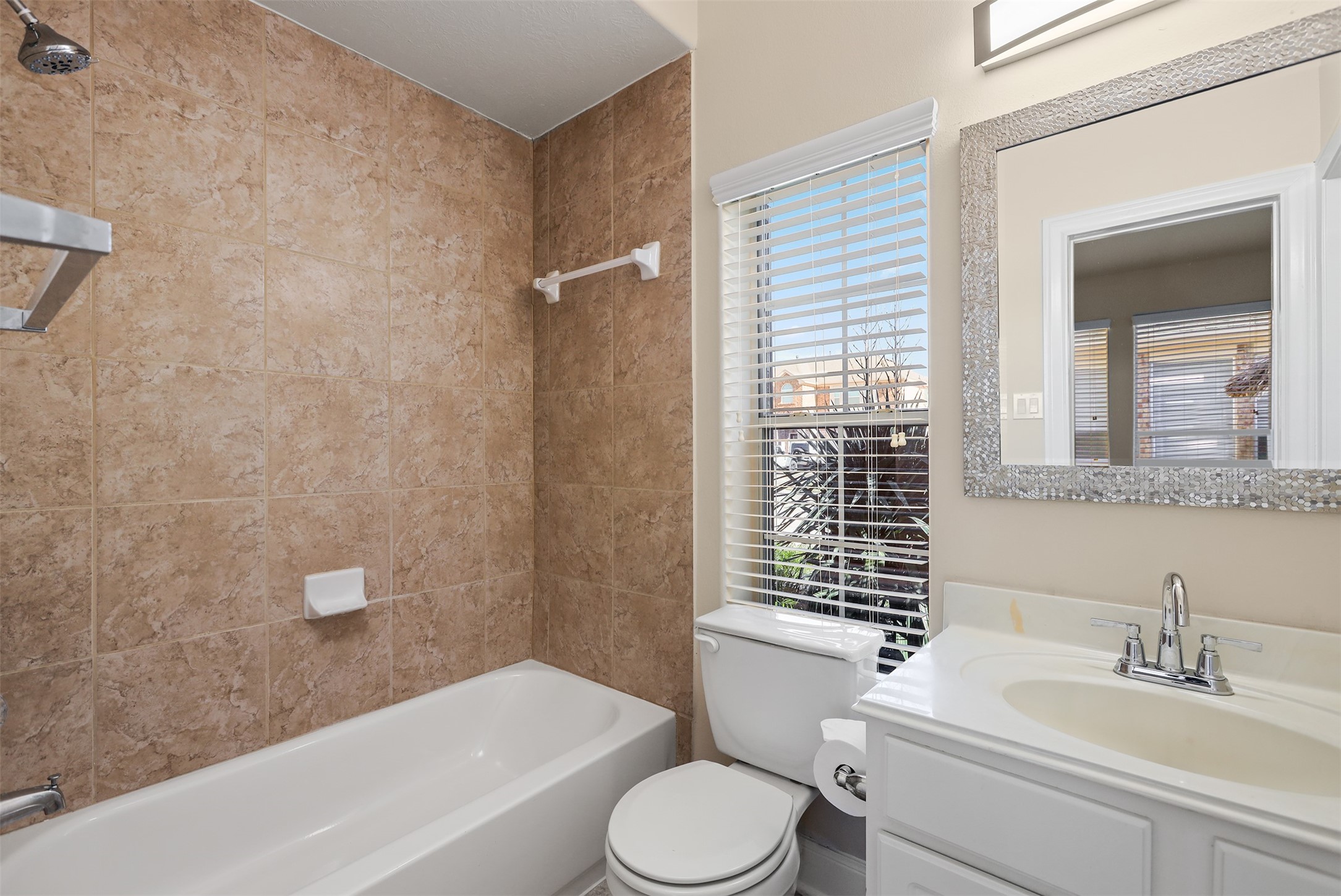 5026 Gulf Stream Lane Bacliff, TX 77518 - Photo 5 of 20 a bathroom with a sink toilet and shower