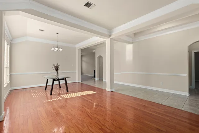 a view of a room with wooden floor and furniture