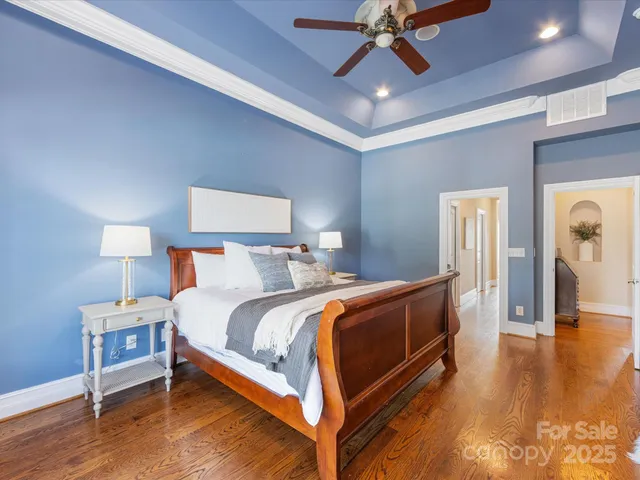 a bedroom with bed and wooden floor