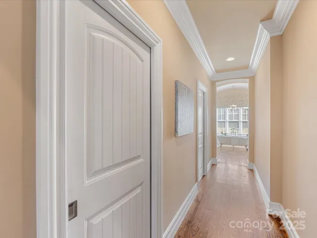 a view of a hallway with wooden floor and entryway