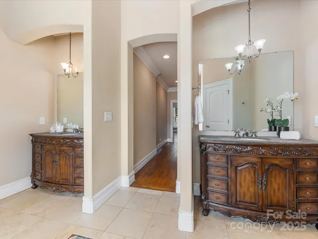 a spacious bathroom with a granite countertop sink a mirror and a shower