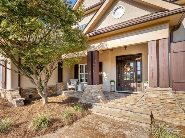 a view of a house with snow on the road