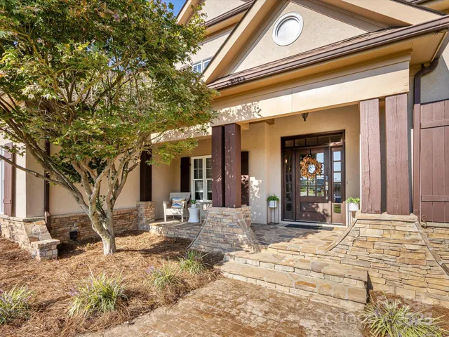 a view of a house with snow on the road