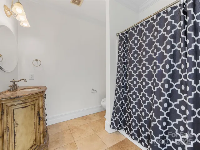 a bathroom with a black white checkered floor