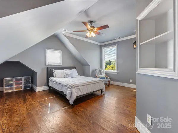 a spacious bedroom with a bed and a chandelier