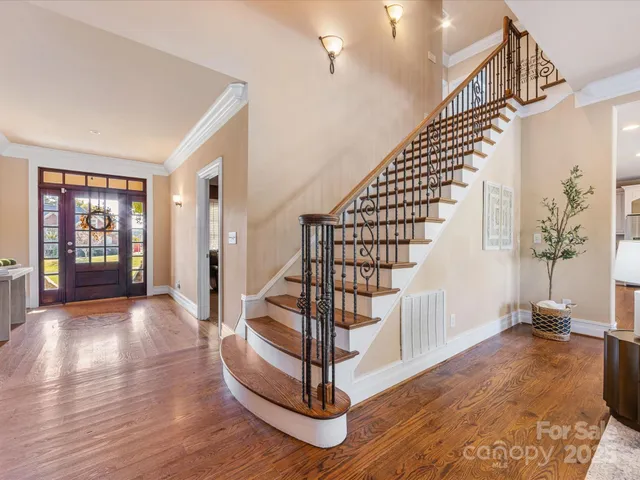 a view of entryway with wooden floor and stairs