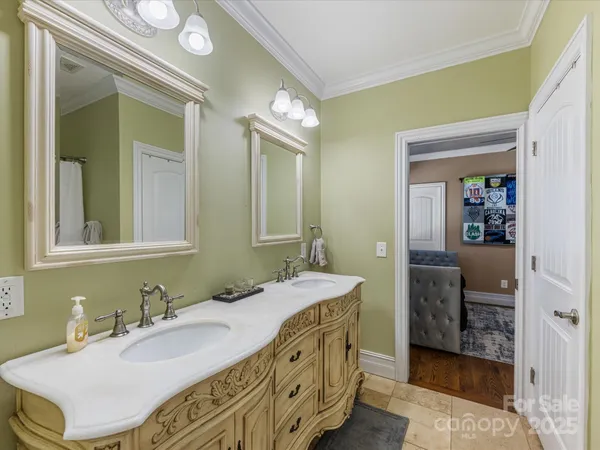 a spacious bathroom with a sink double vanity and a mirror