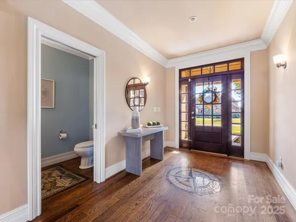 a living room with furniture a window and wooden floor