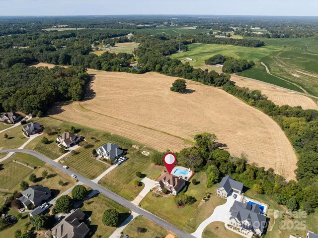 an aerial view of a house with a swimming pool