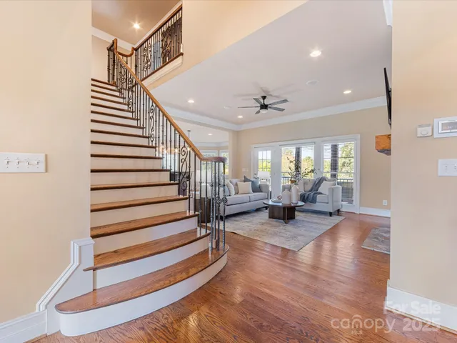 a living room with fireplace furniture and a wooden floor