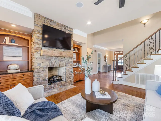 a living room with fireplace furniture and a flat screen tv