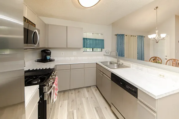 a kitchen with a sink stove and cabinets