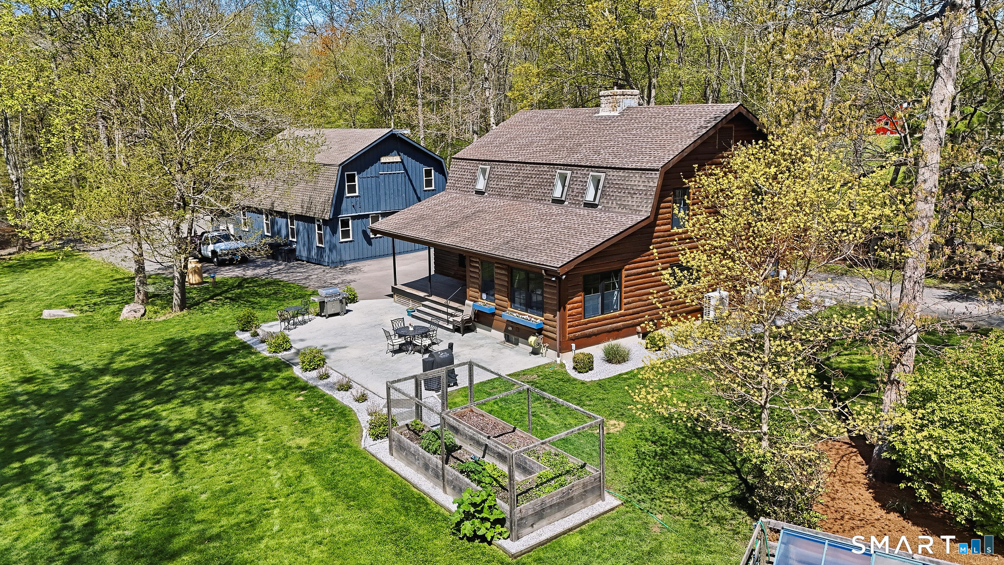 61 Mystic Road North Stonington, CT 06359 - Photo 1 of 40 an aerial view of a house with a yard table and chairs