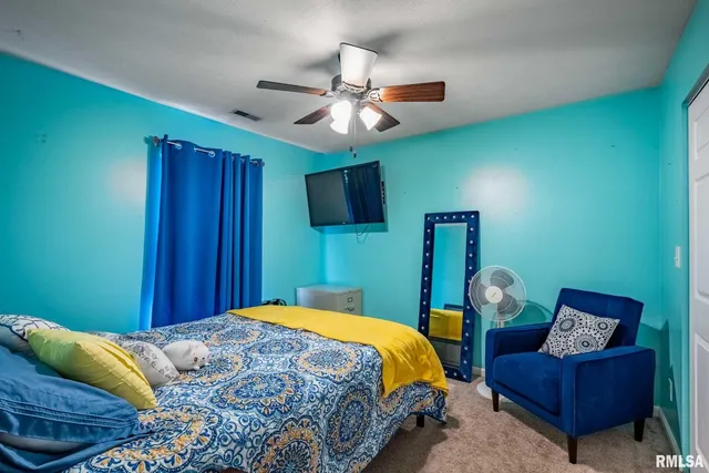 a bedroom with a bed couch and window