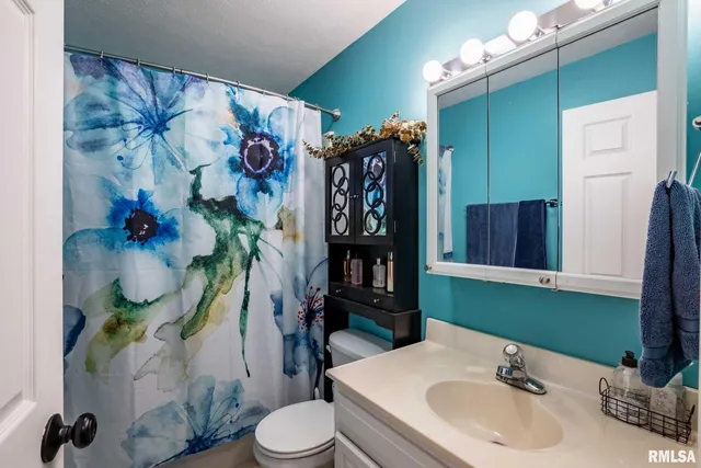 a bathroom with a sink toilet and mirror