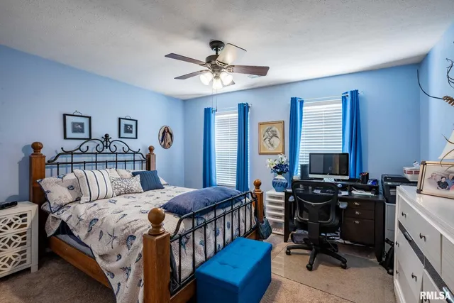 a bedroom with a bed and a desk