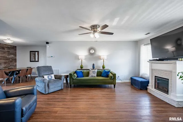 a living room with fireplace furniture and a flat screen tv