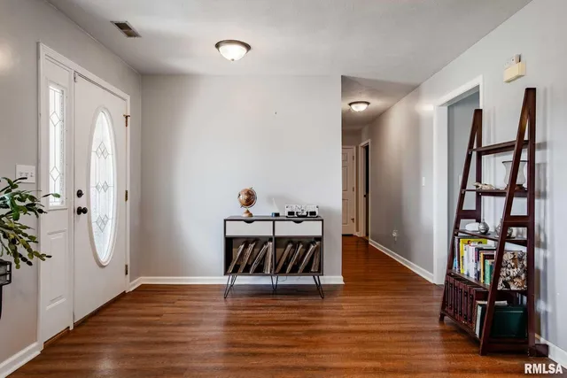 a view of a livingroom with furniture and wooden floor