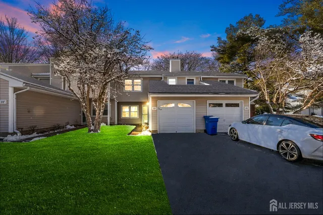 a view of a house with a yard and a garage