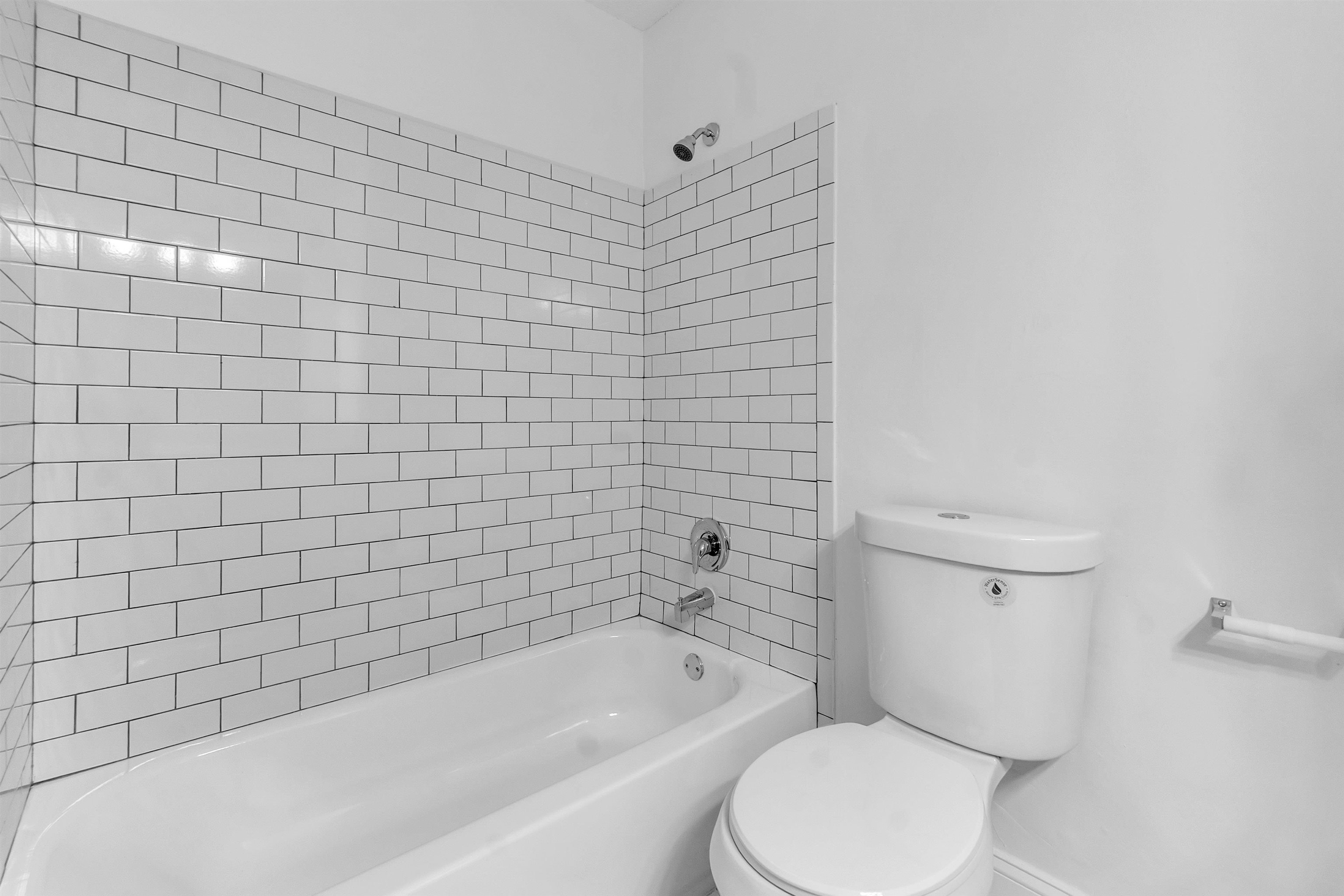 4579 Crump Road Memphis, TN 38141 - Photo 13 of 18 a white toilet and tub sitting next to a bathroom sink