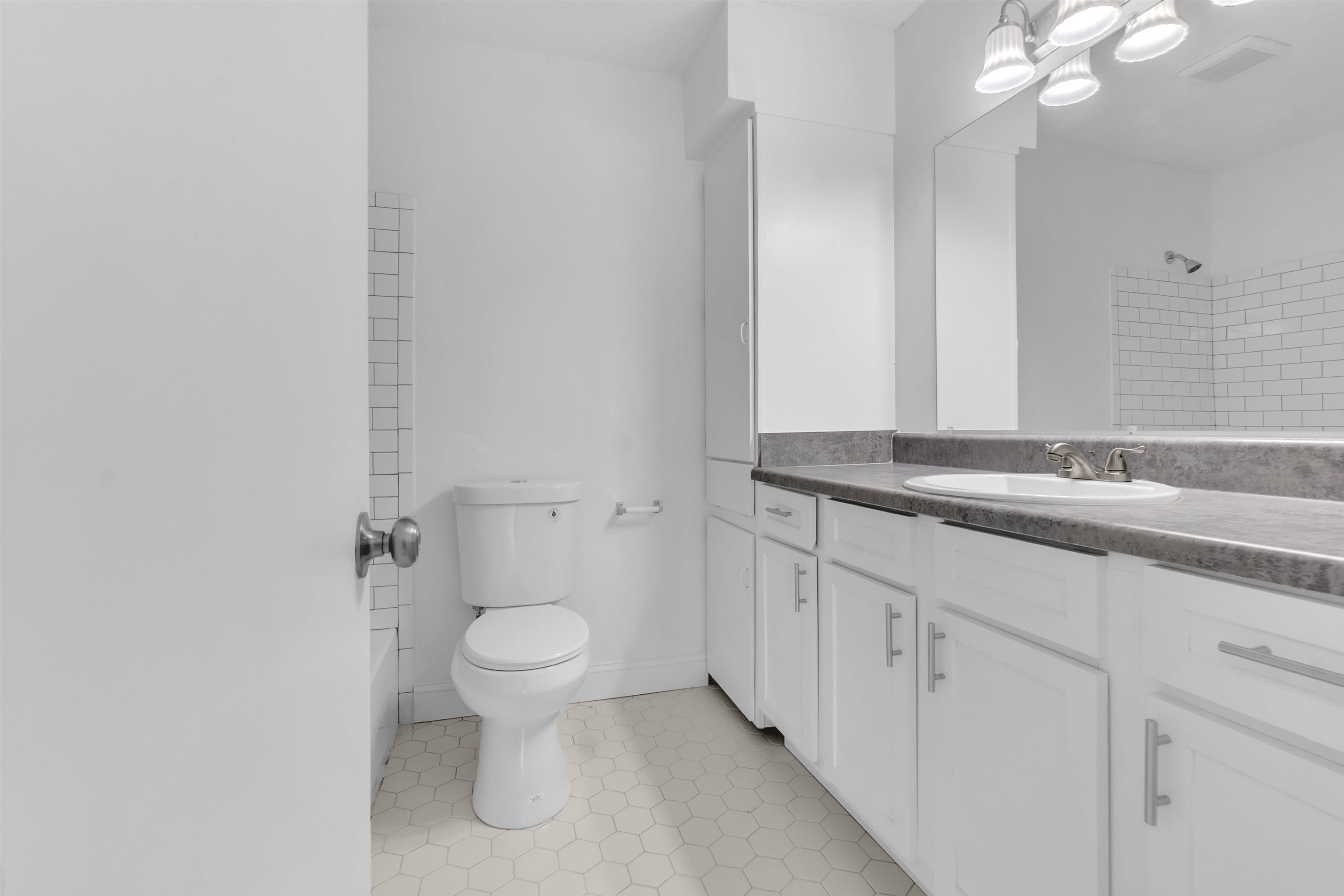 4579 Crump Road Memphis, TN 38141 - Photo 14 of 18 a bathroom with a granite countertop sink a toilet and a mirror