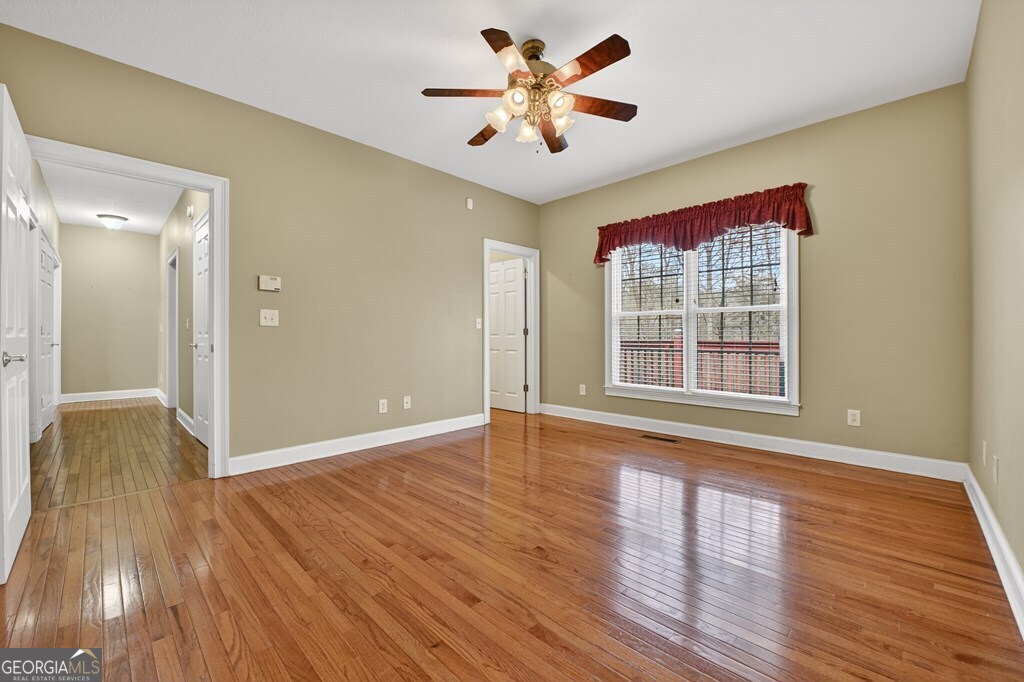 220 Oak Ridge Road Ellijay, GA 30536 - Photo 16 of 36 a view of an empty room with wooden floor and a window