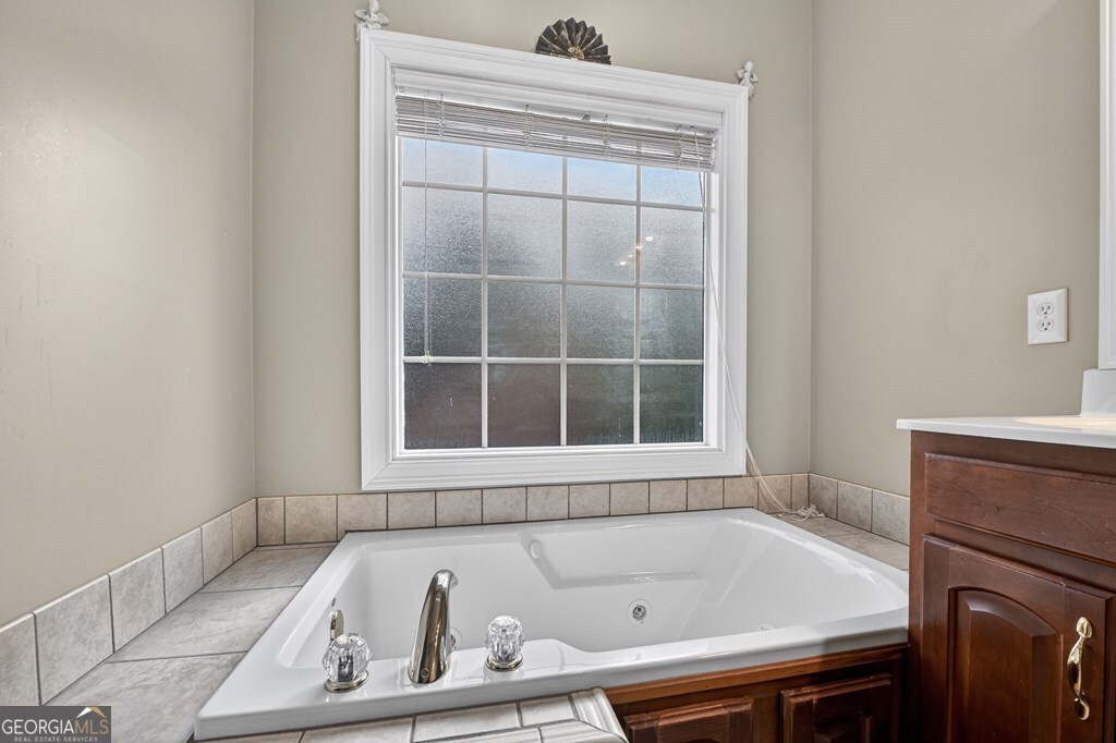 220 Oak Ridge Road Ellijay, GA 30536 - Photo 18 of 36 a bathroom with a bathtub and a window