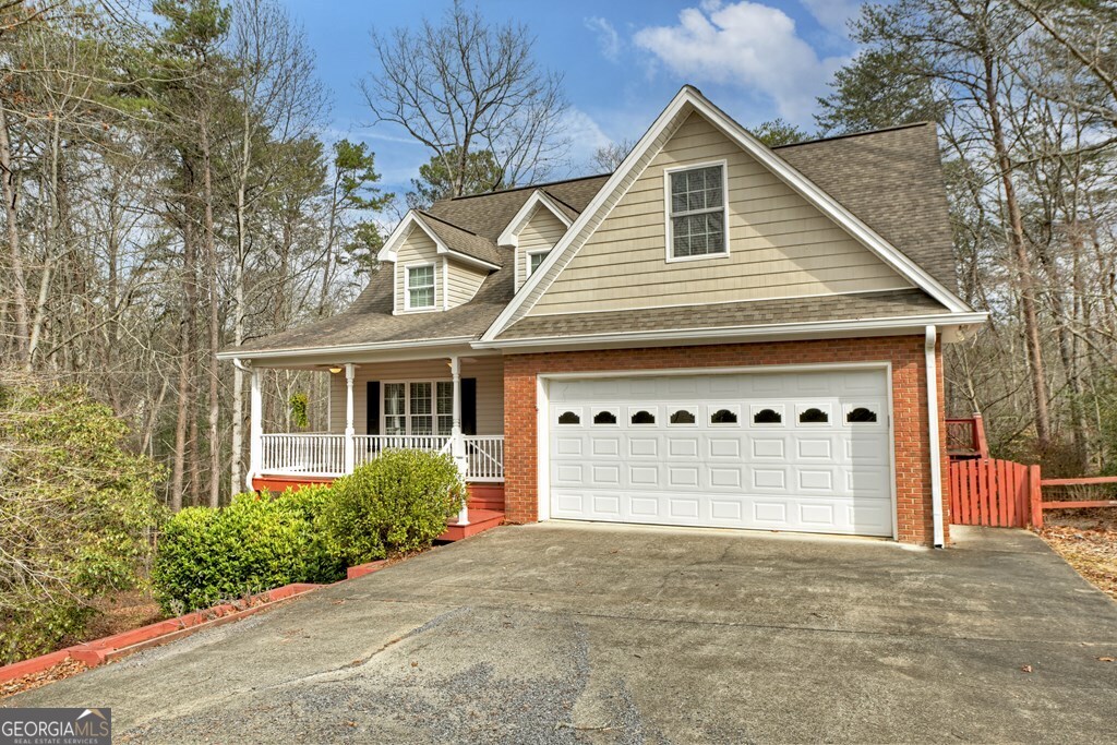 220 Oak Ridge Road Ellijay, GA 30536 - Photo 2 of 36 a front view of a house with a yard and garage