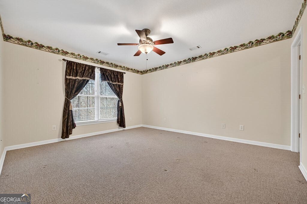 220 Oak Ridge Road Ellijay, GA 30536 - Photo 22 of 36 an empty room with windows and fan