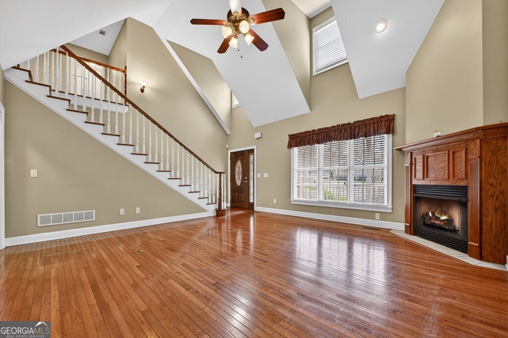 220 Oak Ridge Road Ellijay, GA 30536 - Photo 4 of 36 a view of an empty room with wooden floor fireplace and a window