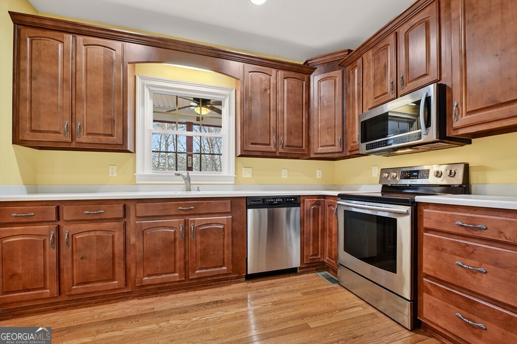220 Oak Ridge Road Ellijay, GA 30536 - Photo 8 of 36 a kitchen with stainless steel appliances granite countertop a stove microwave and cabinets
