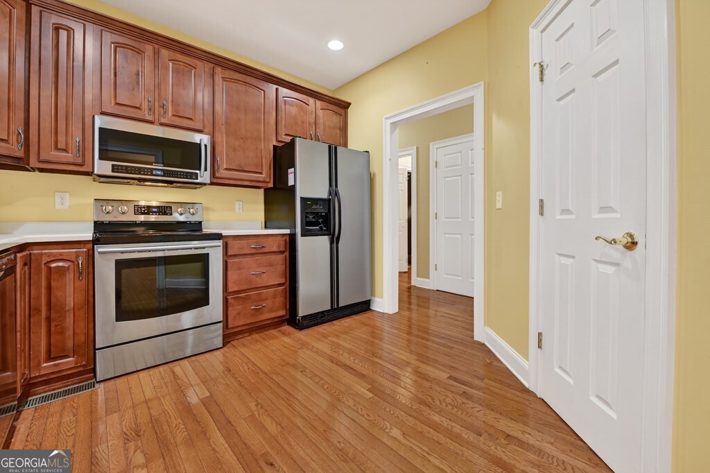 220 Oak Ridge Road Ellijay, GA 30536 - Photo 9 of 36 a kitchen with stainless steel appliances a stove a microwave and cabinets