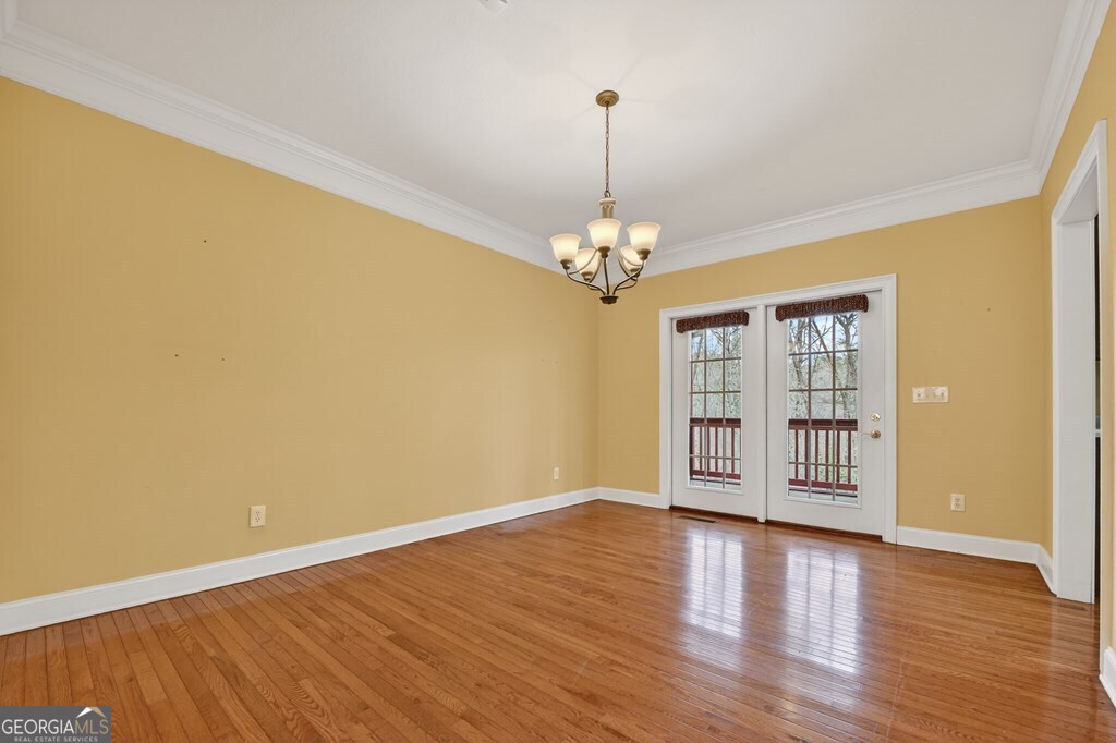 220 Oak Ridge Road Ellijay, GA 30536 - Photo 10 of 36 a view of an empty room with wooden floor and a window