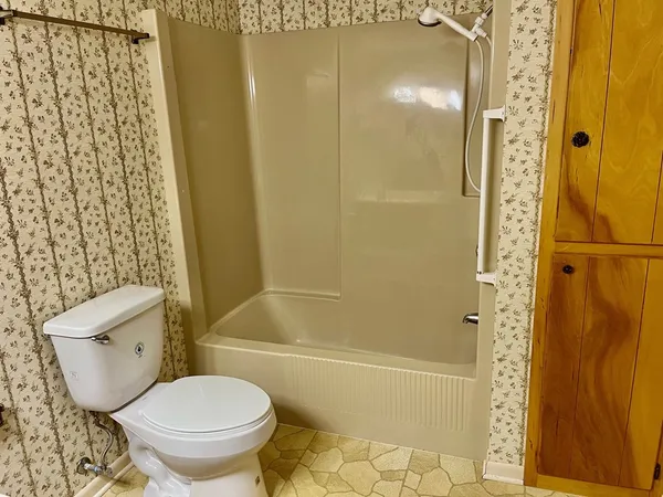 a bathroom with a toilet and shower