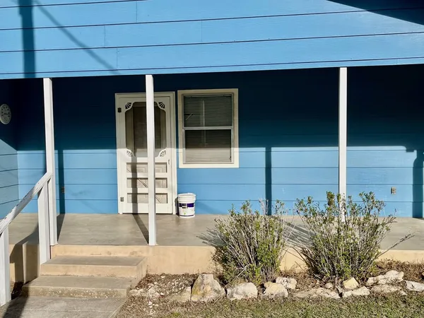 a view of house with large windows and pathway