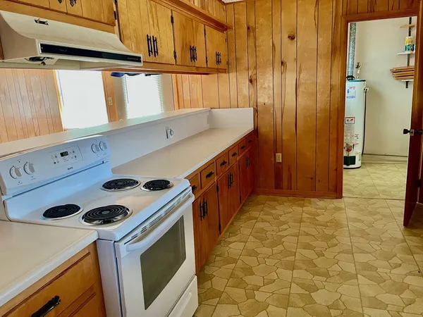 a kitchen with a stove and a refrigerator