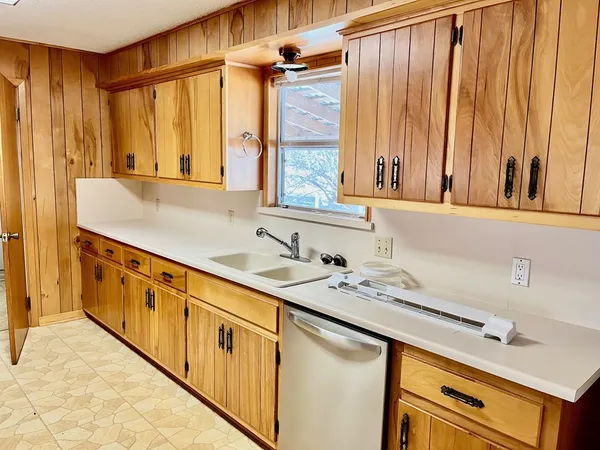 a kitchen with stainless steel appliances a sink and cabinets