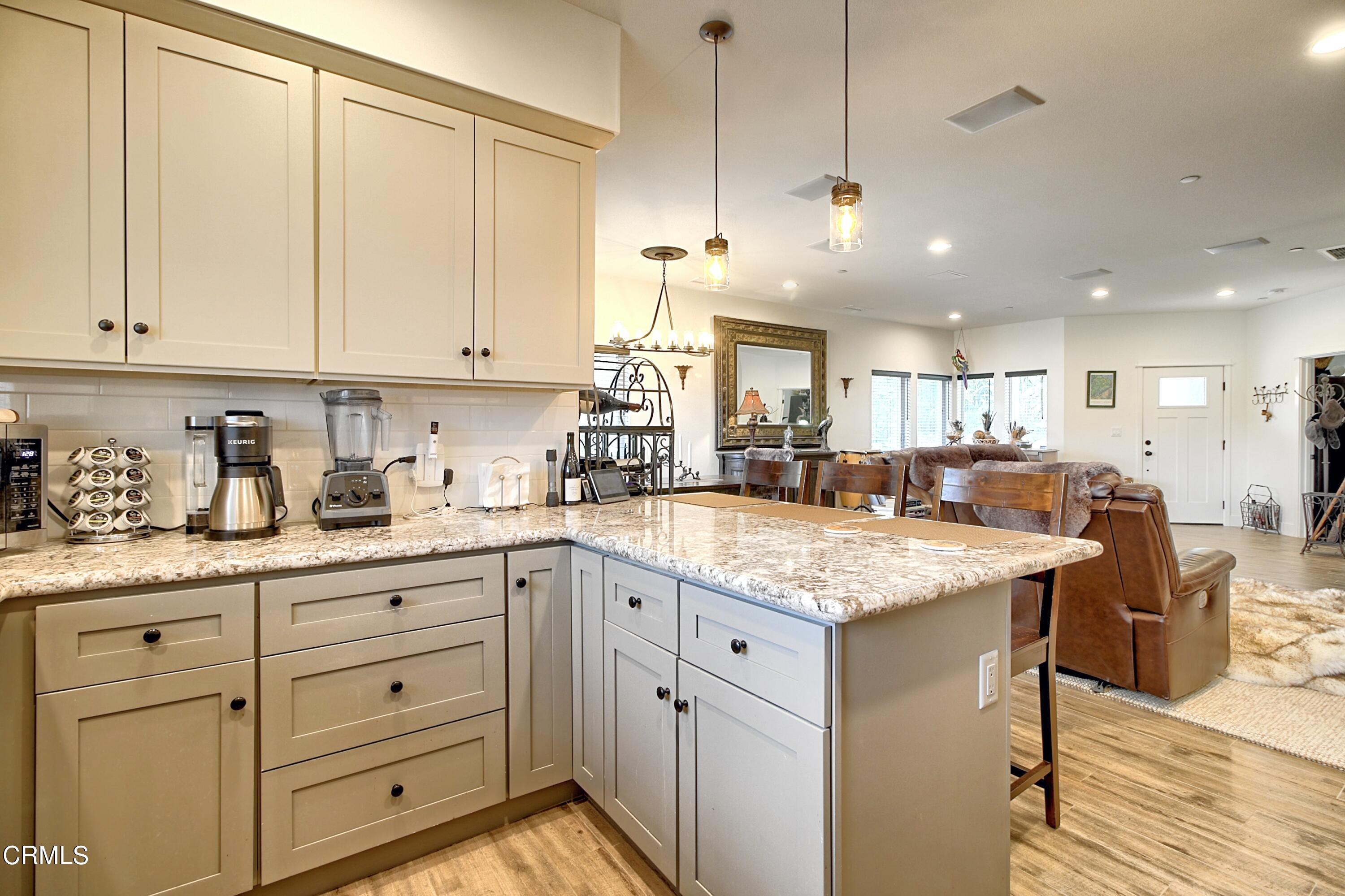 357 Los Cabos Lane Ventura, CA 93001 - Photo 12 of 44 a kitchen with white cabinets sink and stove