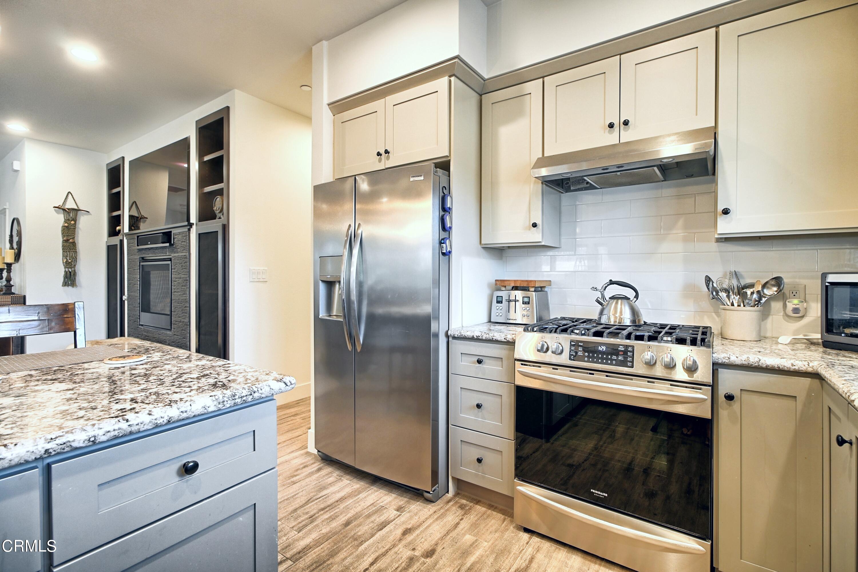 357 Los Cabos Lane Ventura, CA 93001 - Photo 13 of 44 a kitchen with stainless steel appliances granite countertop a sink stove and refrigerator