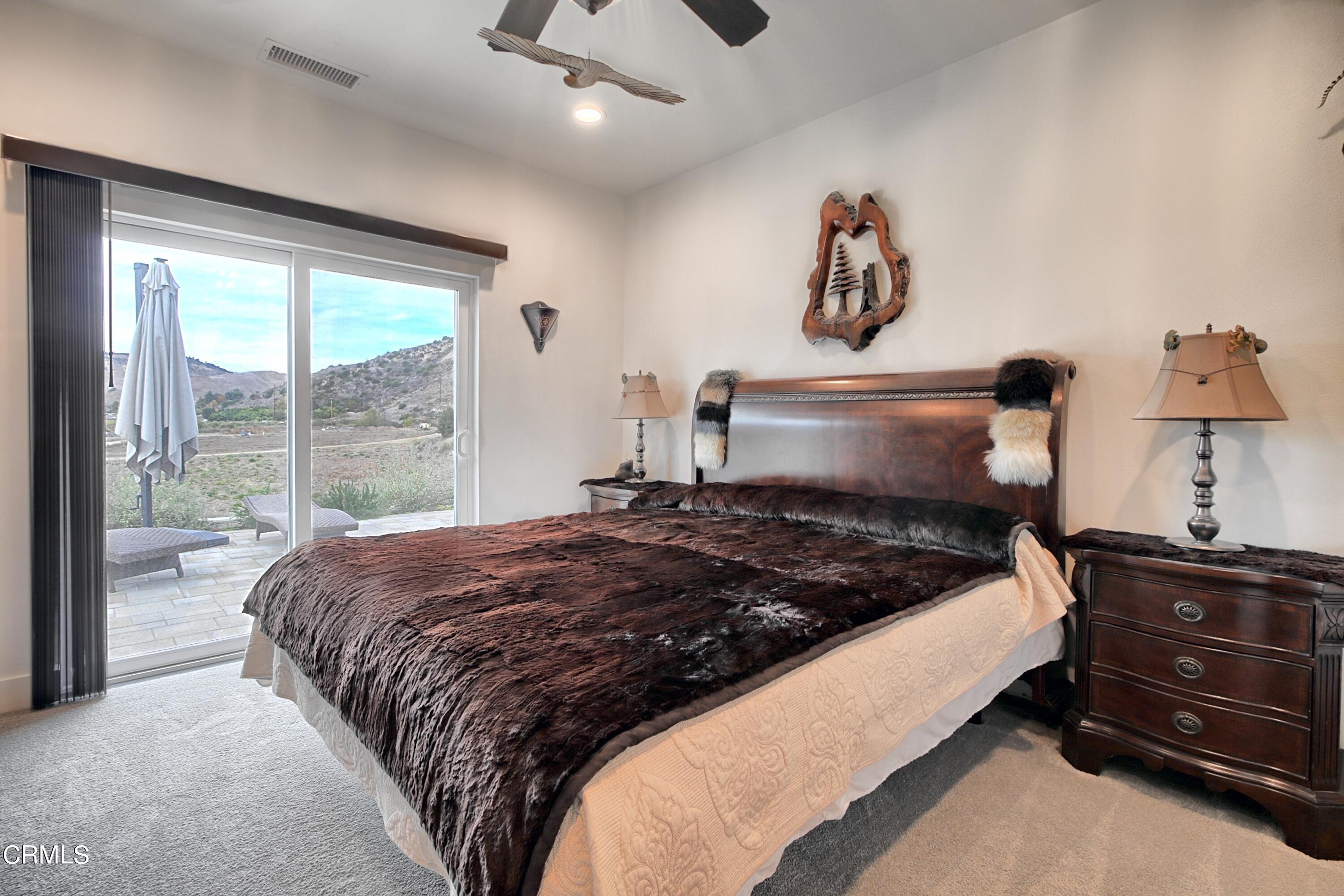 357 Los Cabos Lane Ventura, CA 93001 - Photo 14 of 44 a bedroom with a bed a dresser and a large window